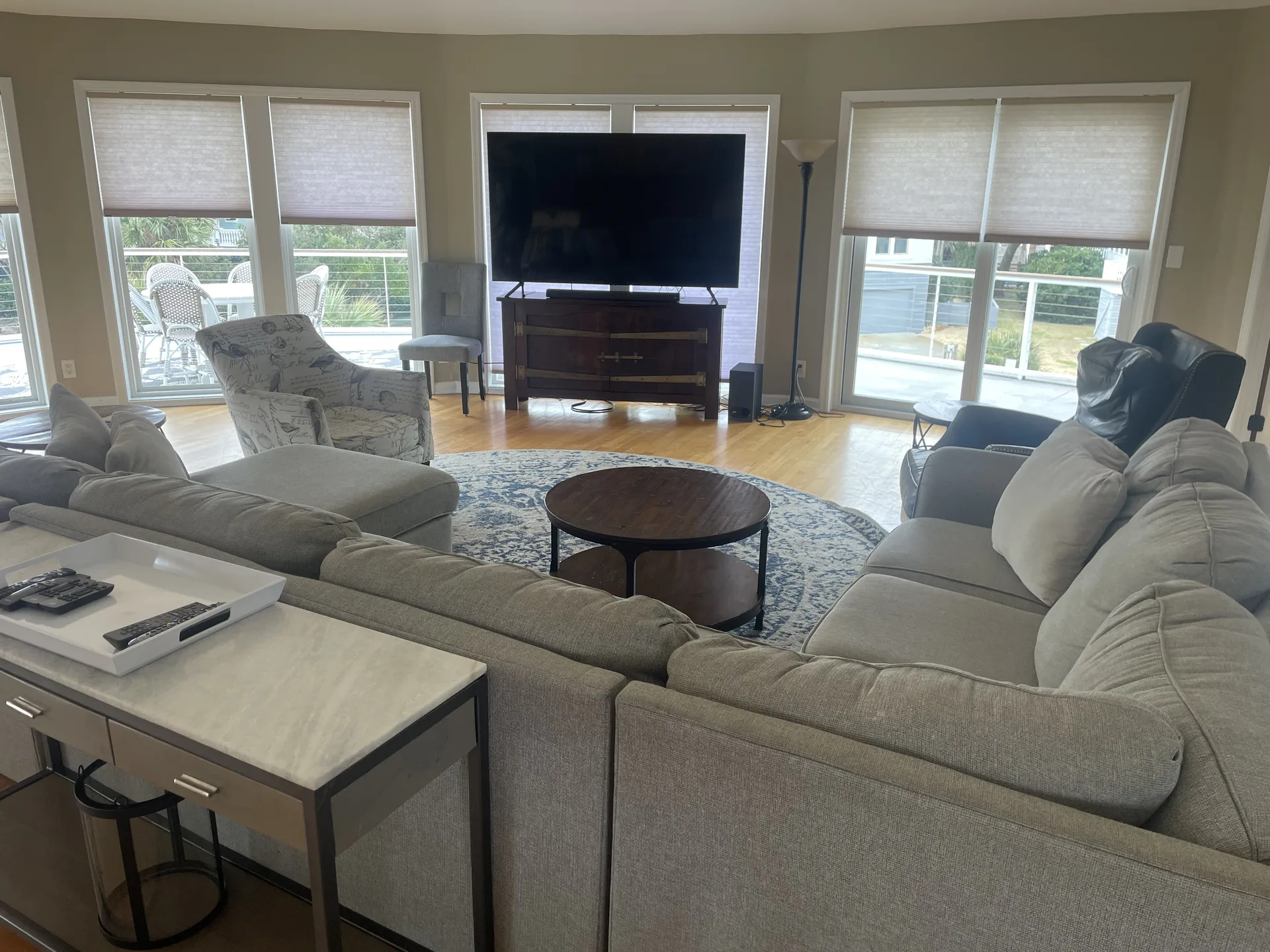Main level living room with large sectional sofa, big-screen TV, and panoramic windows