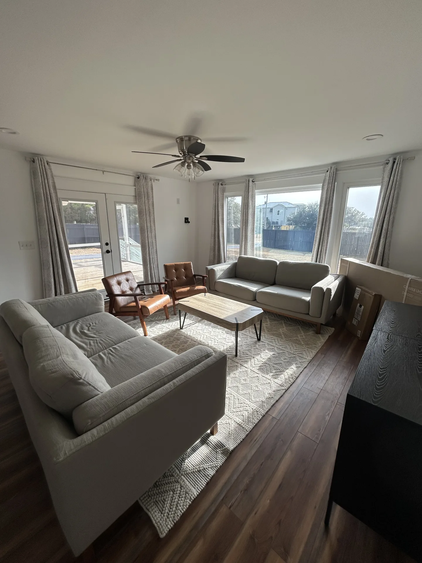 Guest bedroom with gray plaid comforter and cream curtains