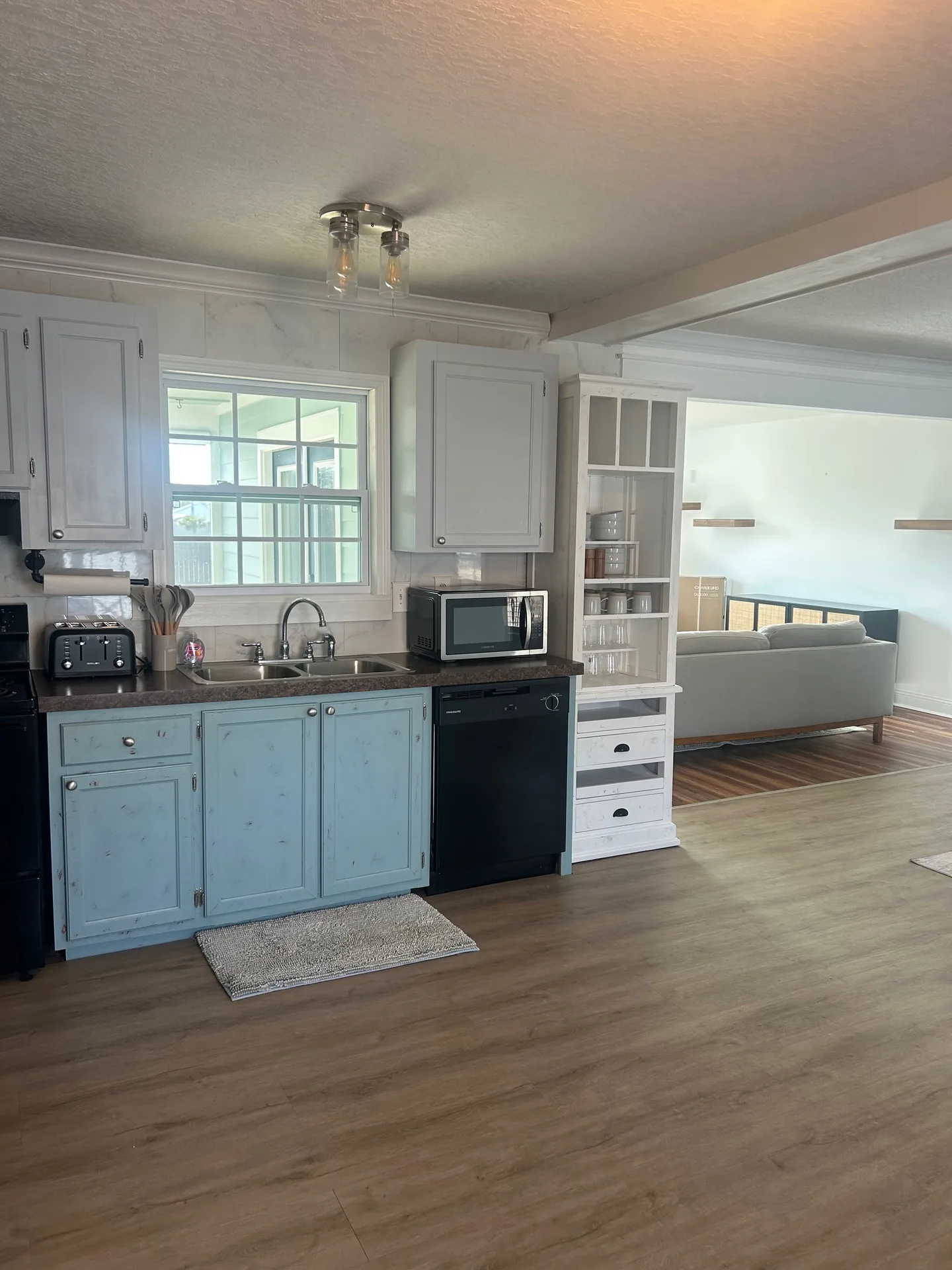 Dining area with charcoal table, upholstered chairs, and blonde wood accent wall